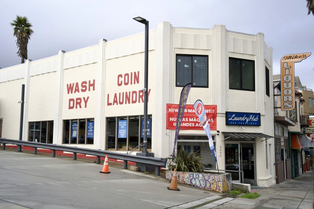 The Laundry Hub storefront on Mission Street in San Francisco with WASH DRY COIN LAUNDRY painted on the building
