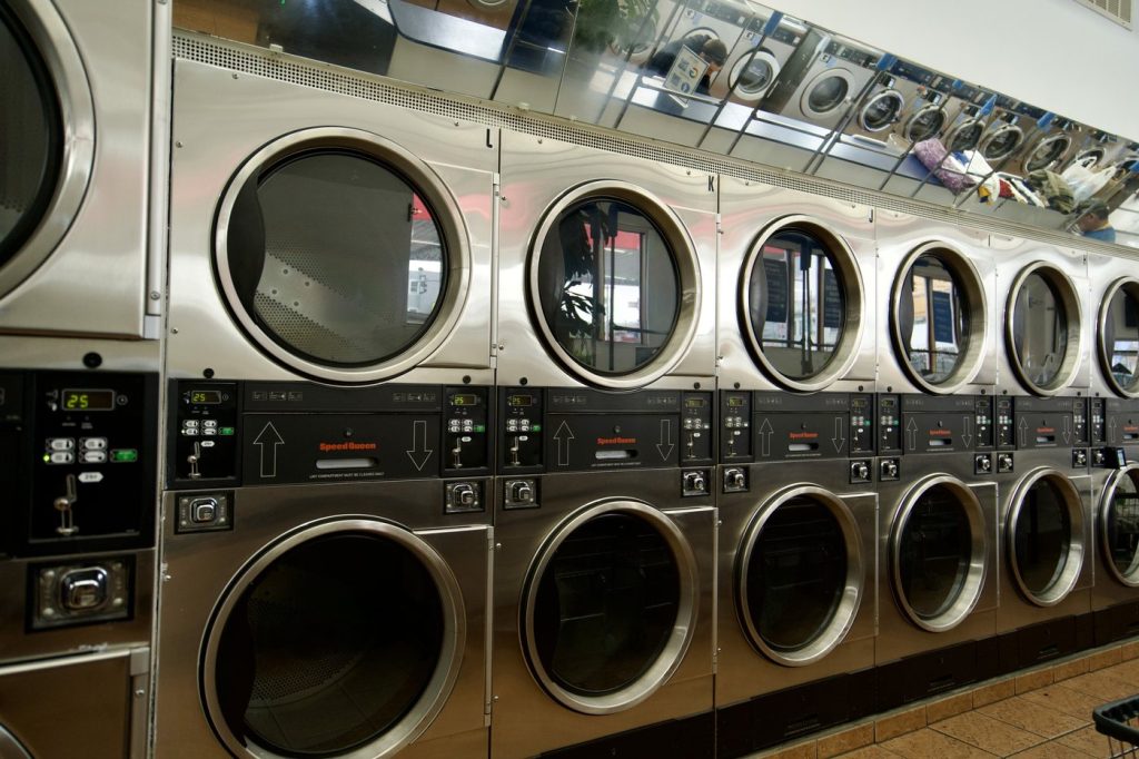 Speed Queen stacked dryers with lit cycle timers at The Laundry Hub laundromat in San Francisco