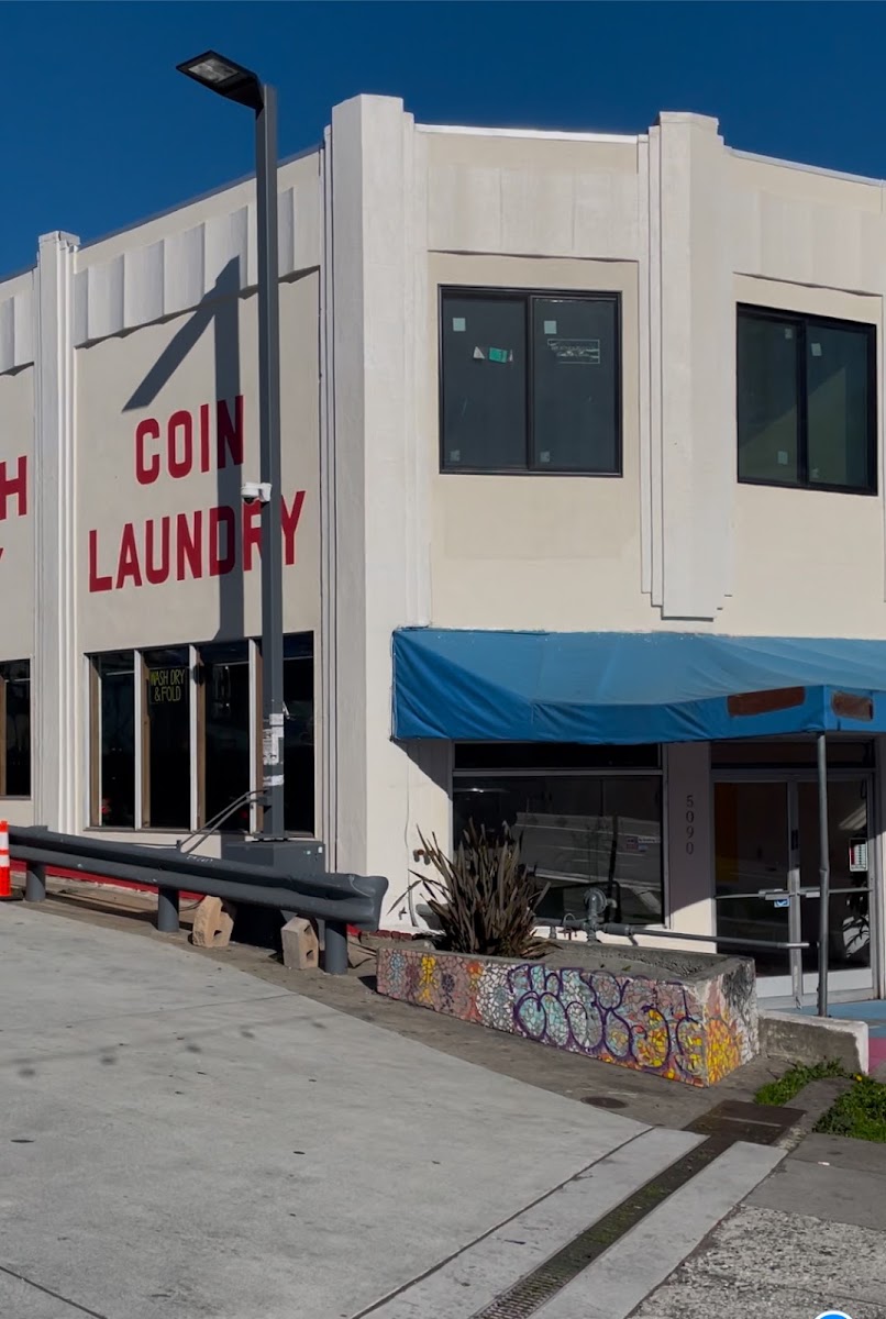 Coin laundry sign on The Laundry Hub SF building in San Francisco