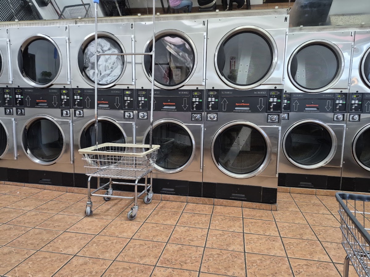 Laundry cart beside commercial washers at The Laundry Hub SF