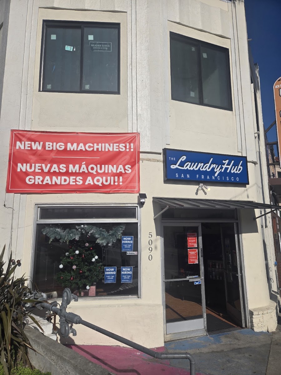 New big machines banner on The Laundry Hub SF storefront on Mission Street